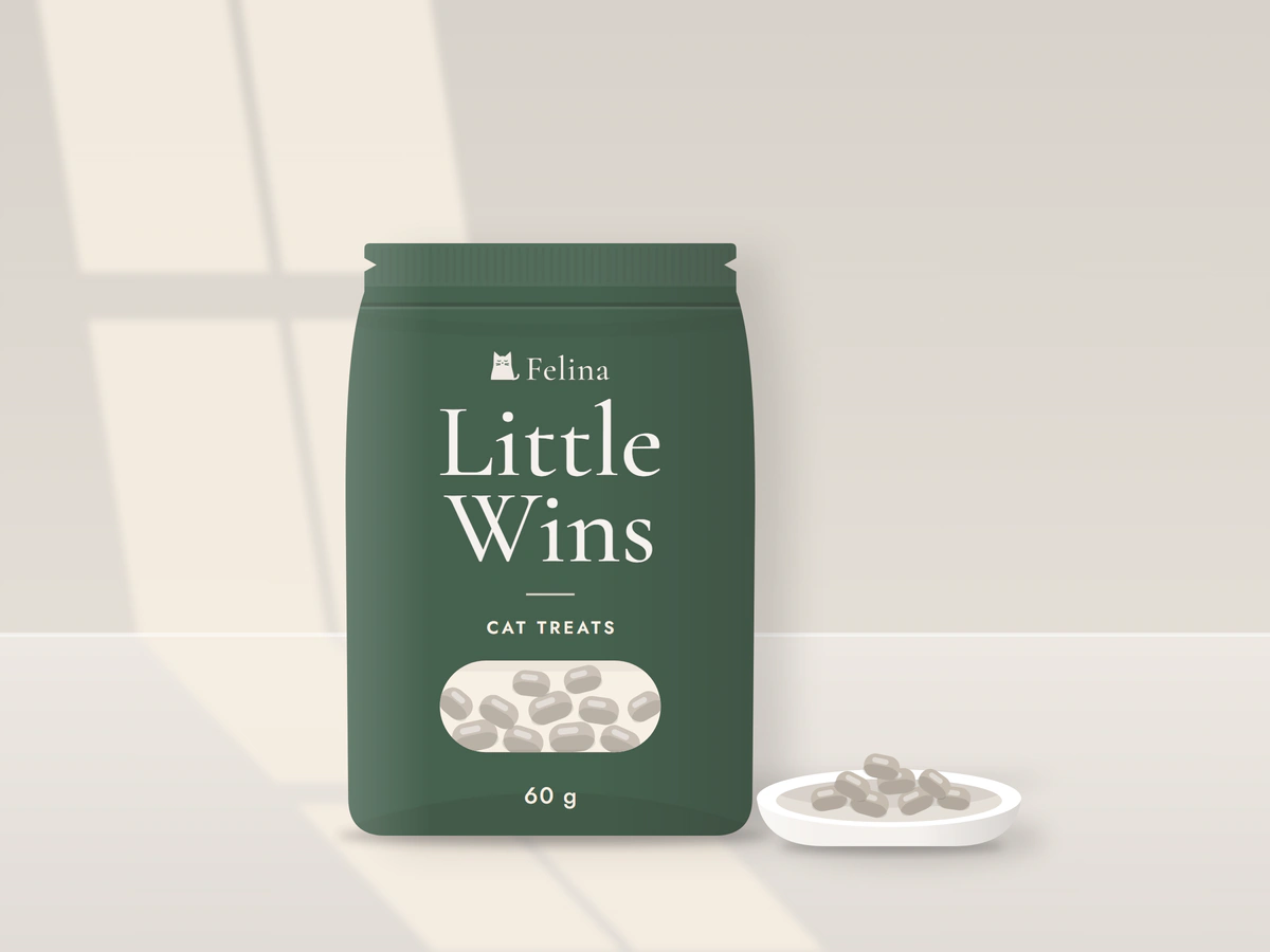 Illustration: a green resealable bag of Little Wins cat treats, 60 g, with a small window showing the soft pieces, next to a white dish with a few pieces