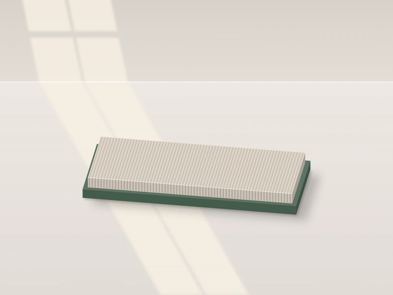 Illustration: a flat scratcher on the floor, corrugated cardboard in a low green tray