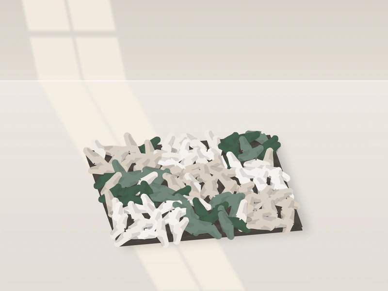 Illustration: a square snuffle mat on the floor, covered in knotted fleece strips in patches of green and pale neutral colours